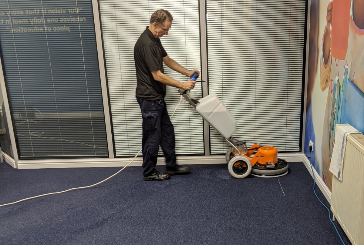 Professional carpet cleaning in an office with an agitator