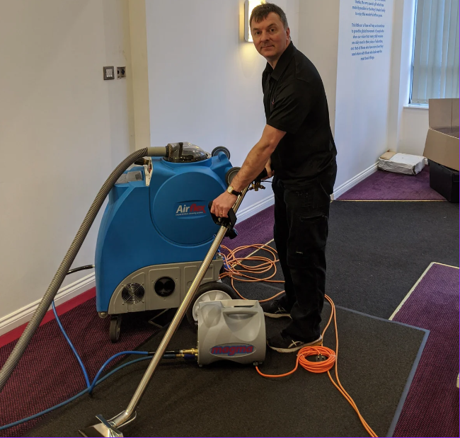 Professional cleaner performing a commercial carpet clean.